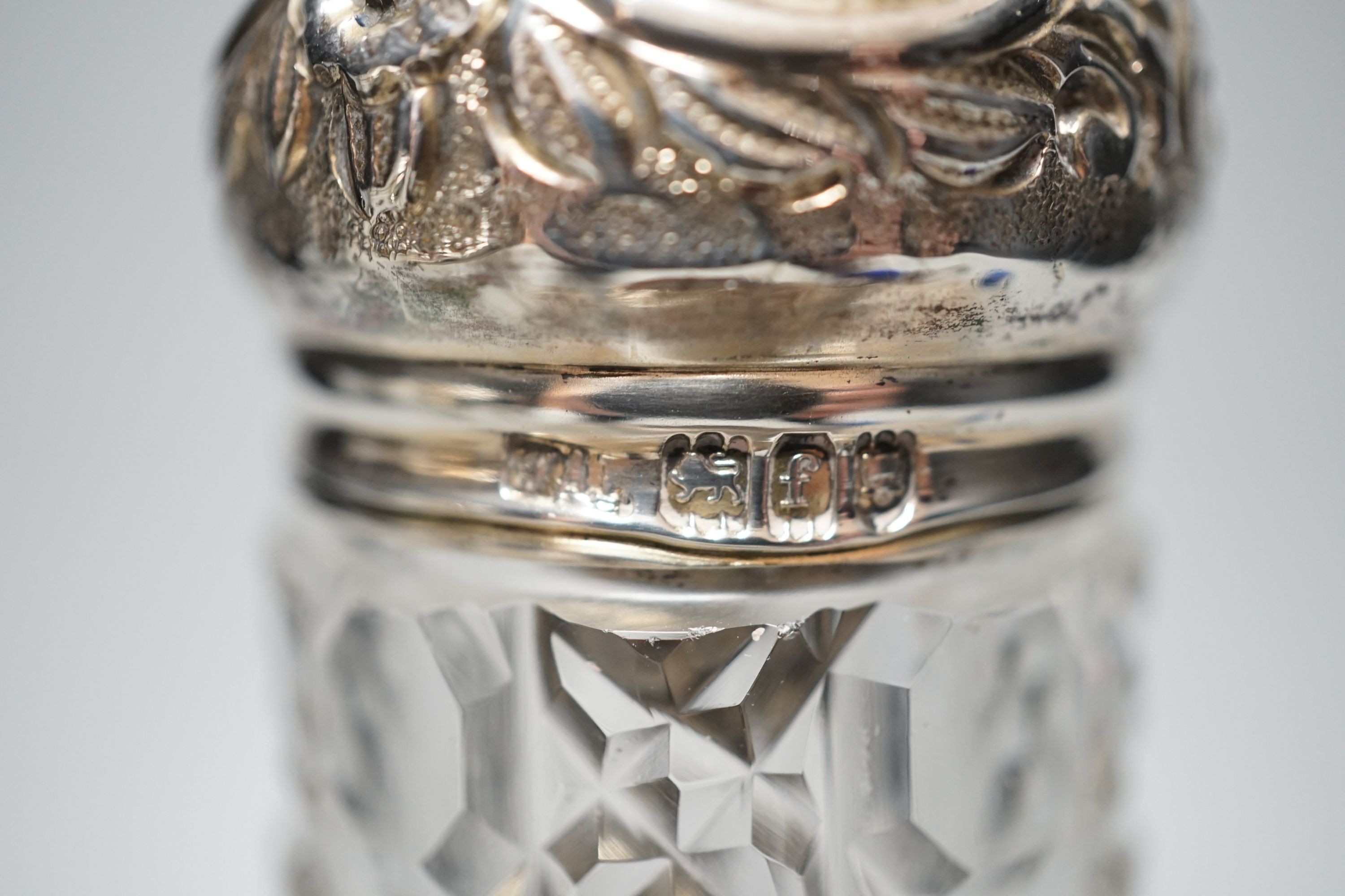 A collection of assorted mainly silver-capped scent bottles and toilet jars, etc. including two gilt metal and enamel.